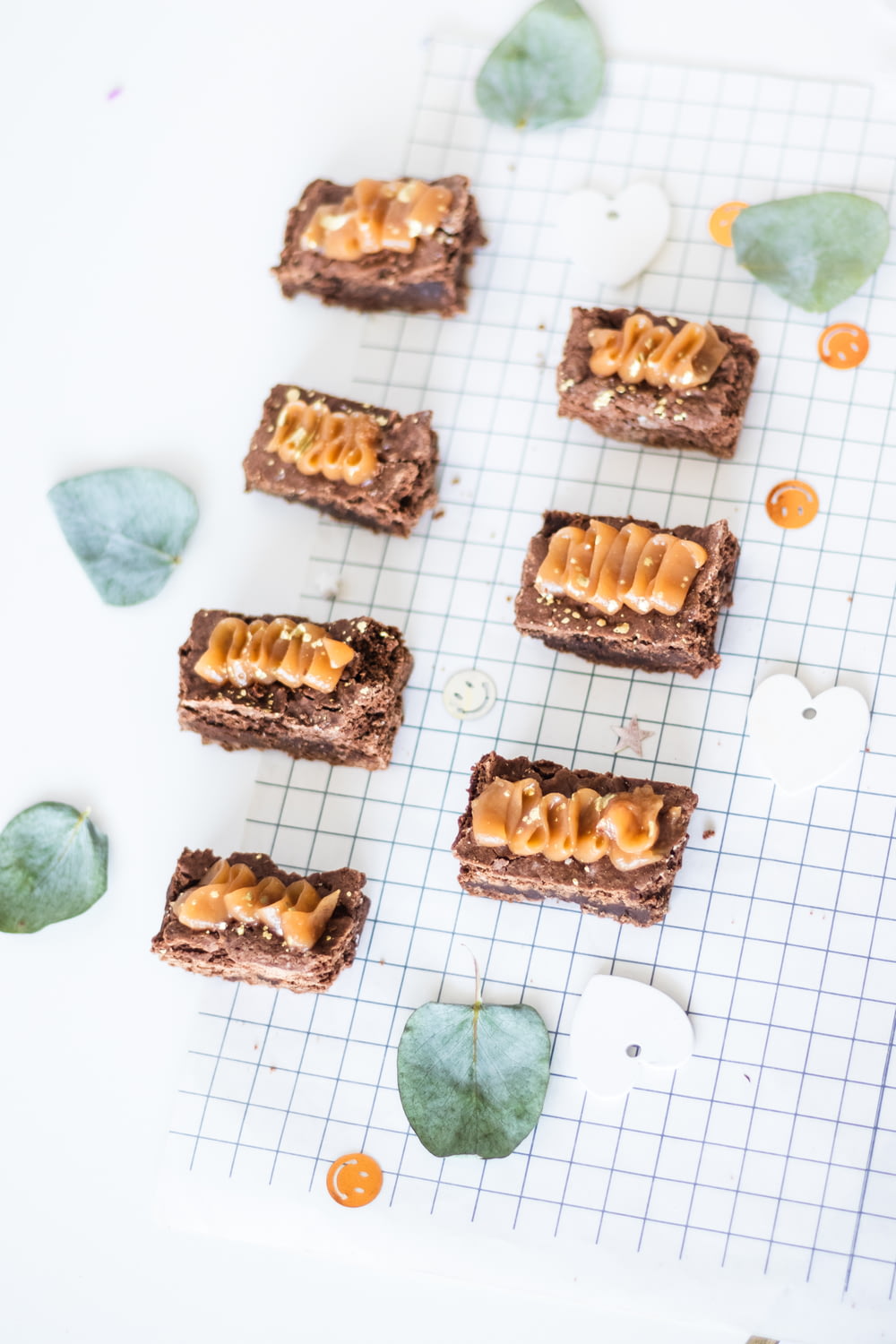 a table topped with brownies covered in peanut butter