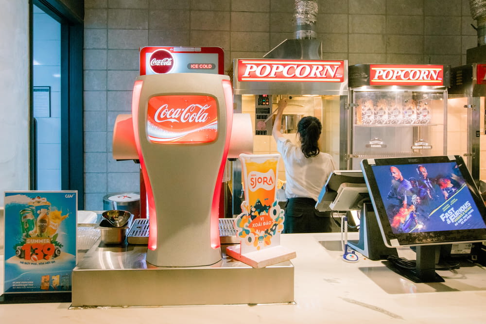 red and white coca cola beverage dispenser