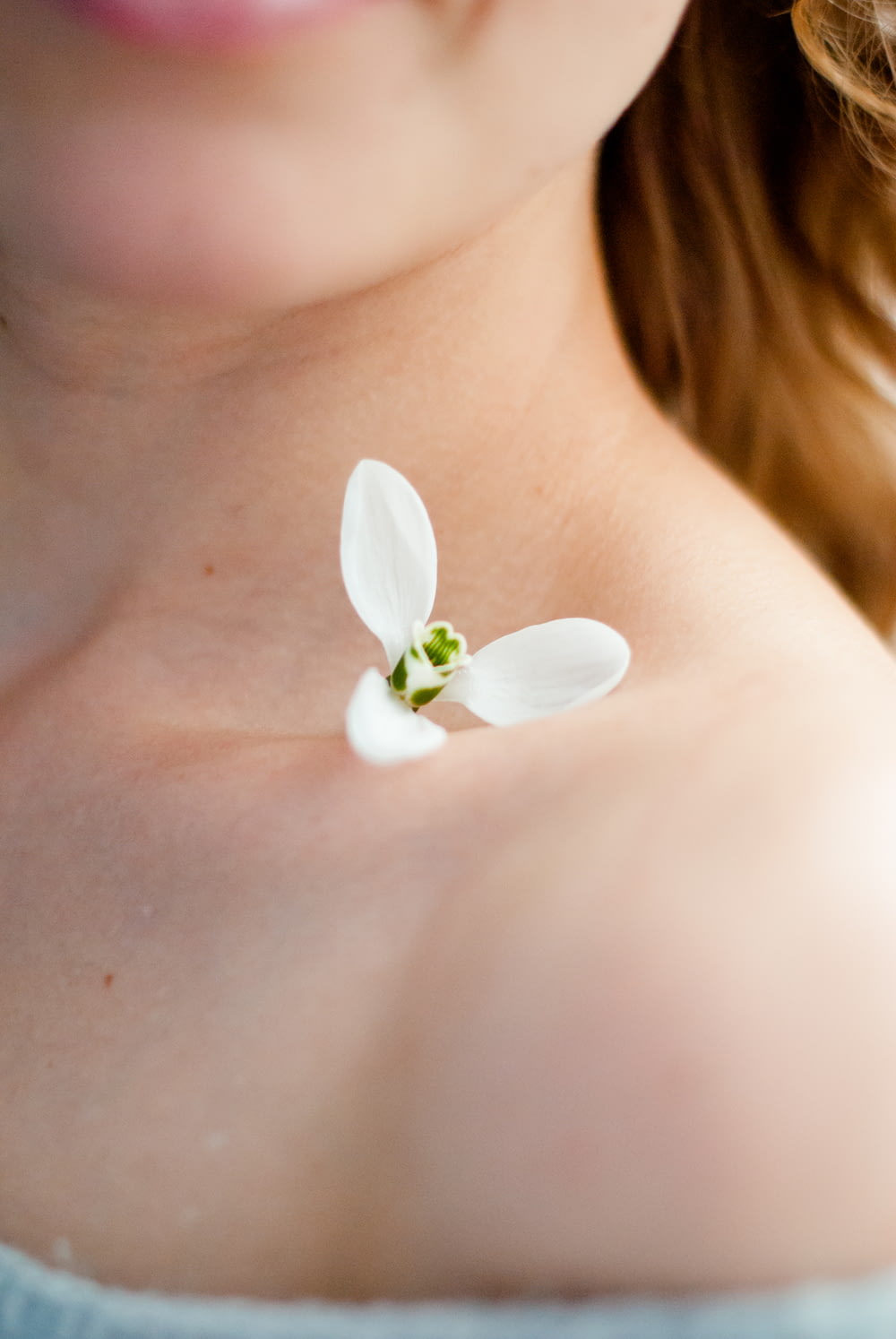white flower on womans breast