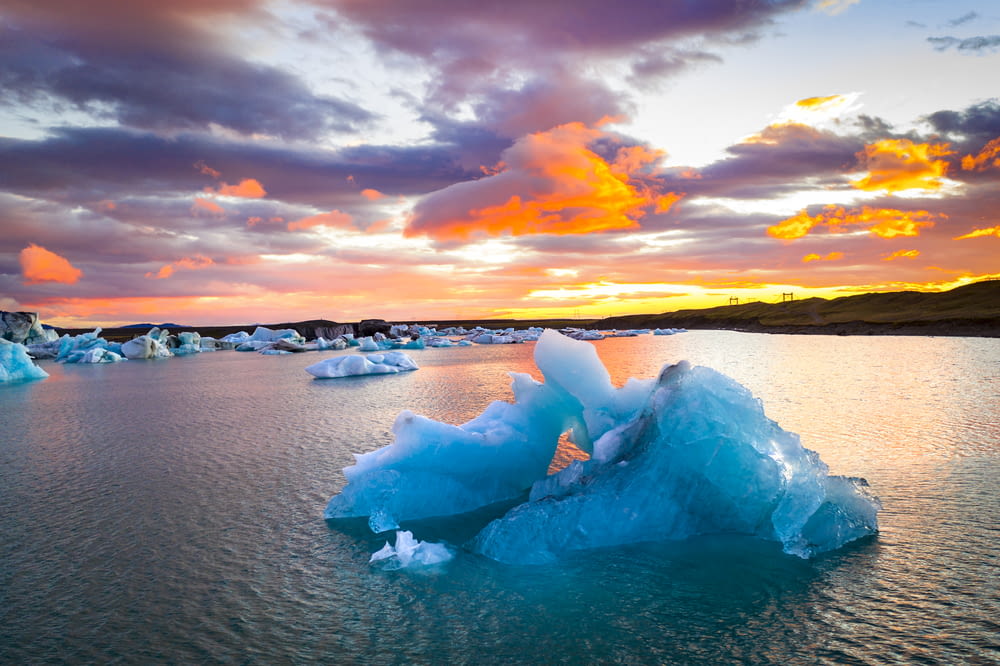 ice blocks on the shore during sunset