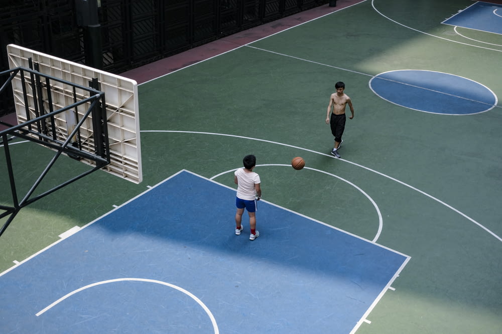 man in blue and white jersey shirt playing basketball