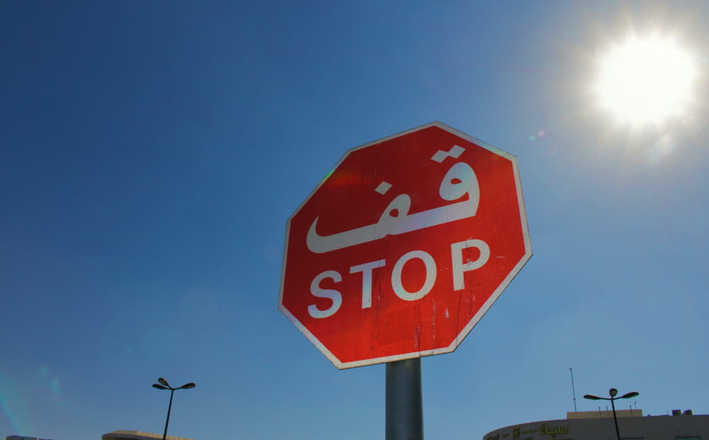 red stop road sign under blue sky during daytime