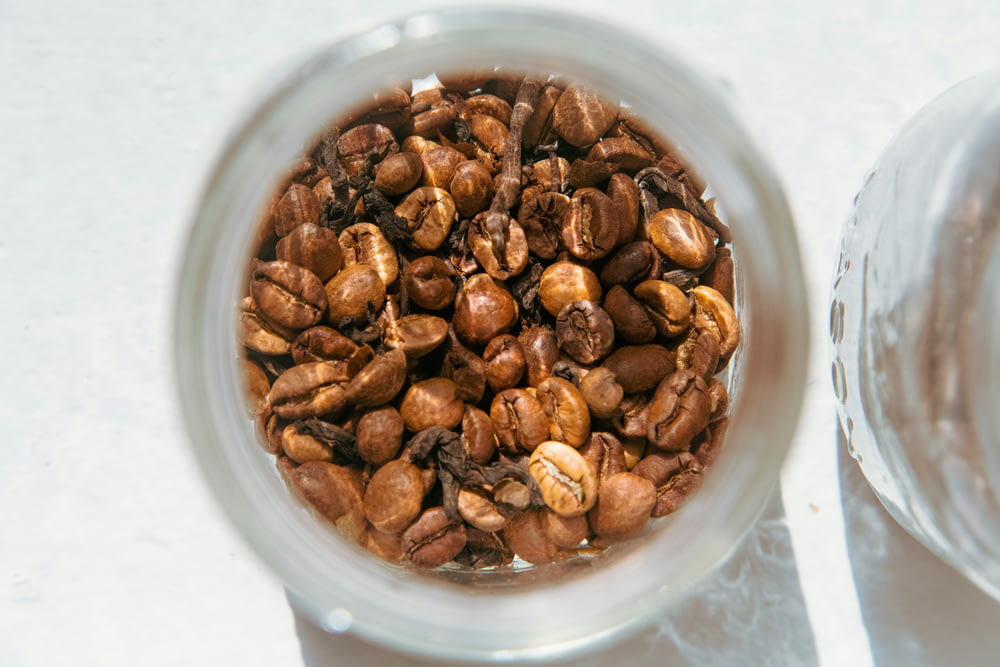 brown coffee beans in clear glass container