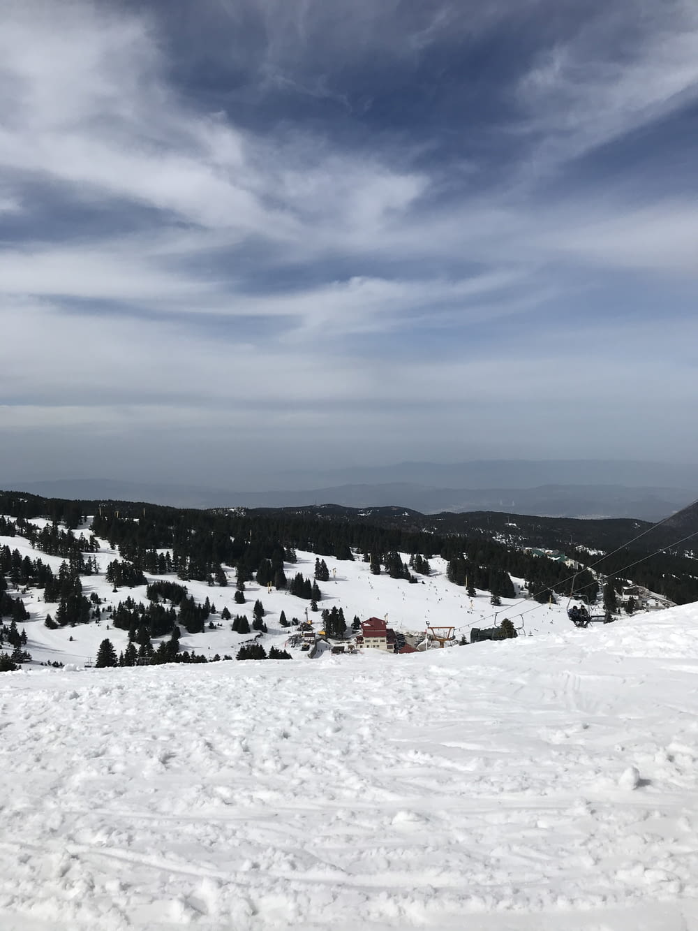 people on snow covered mountain under cloudy sky during daytime