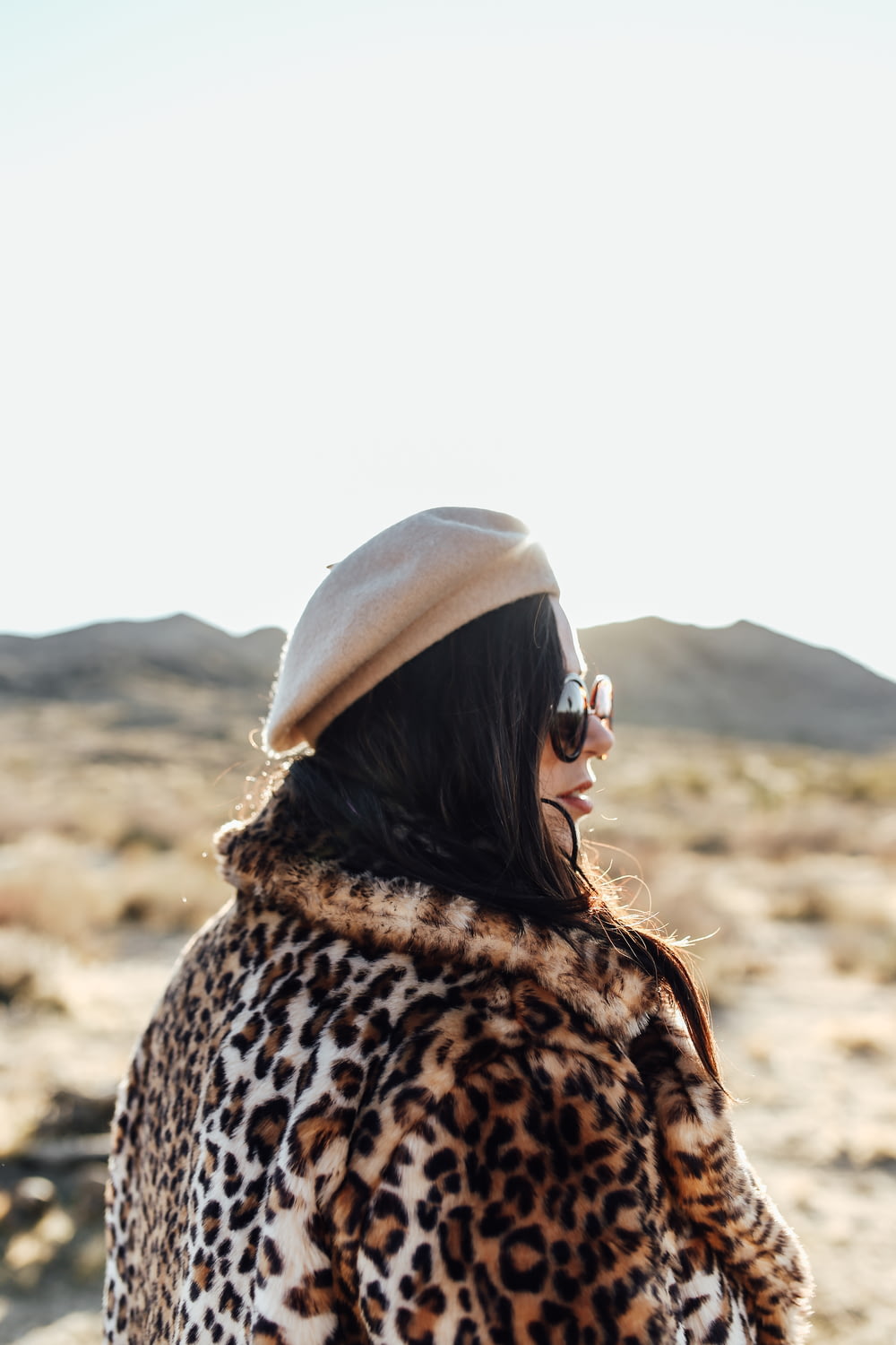 woman in brown and black leopard print coat wearing black sunglasses