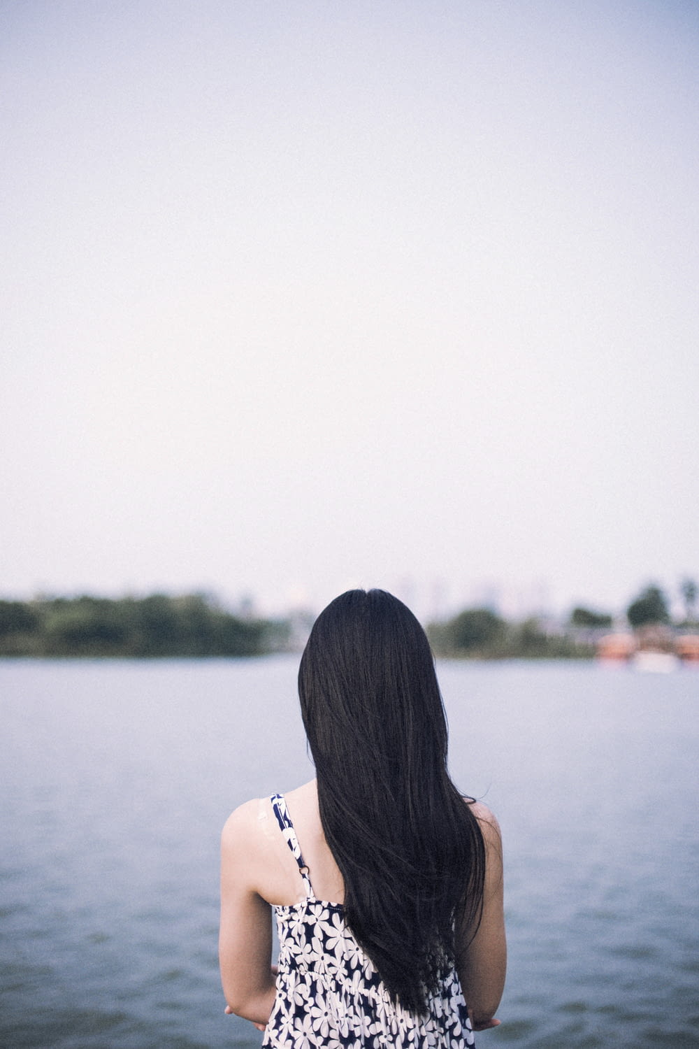 woman in white bikini top standing near body of water during daytime