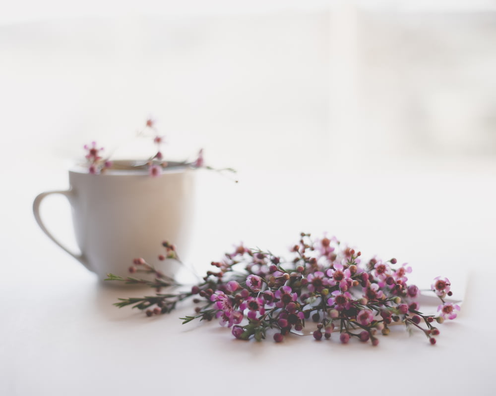 pink and green flowers on white ceramic teacup