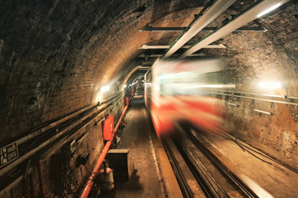 red and white train on tunnel