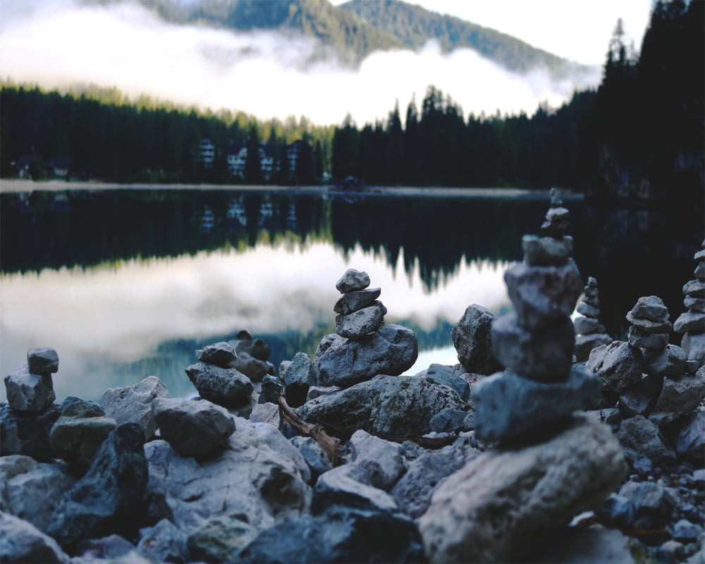 gray rocks on lake during daytime