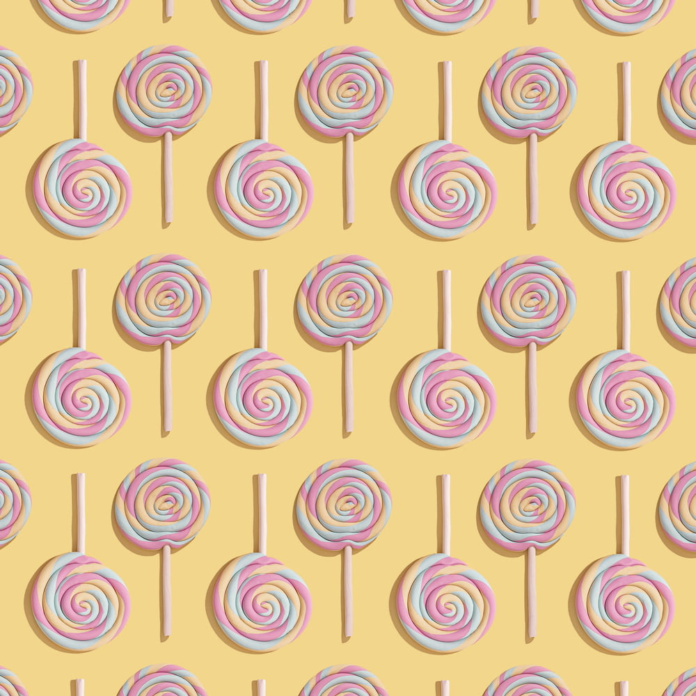 a pattern of lollipops on a yellow background