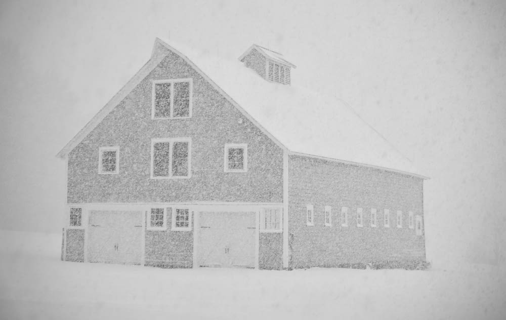 grayscale photo of house on snow covered ground