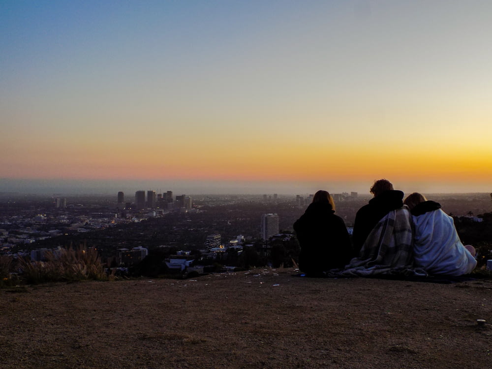 people sitting on ground during sunset