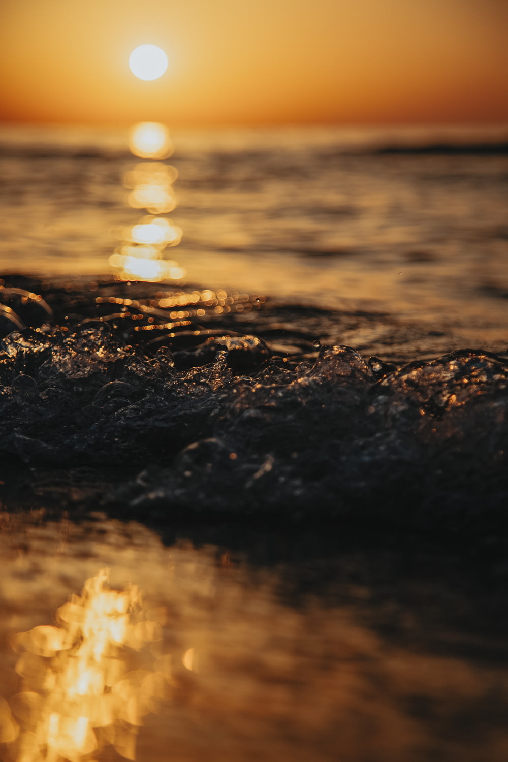 water splash on the shore during sunset