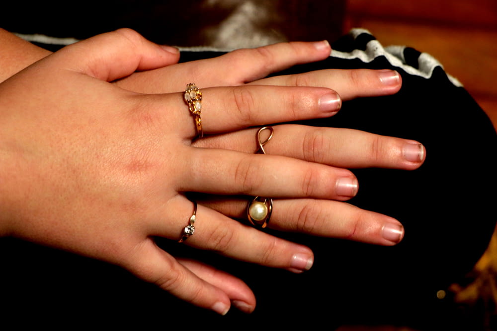 person wearing gold diamond ring