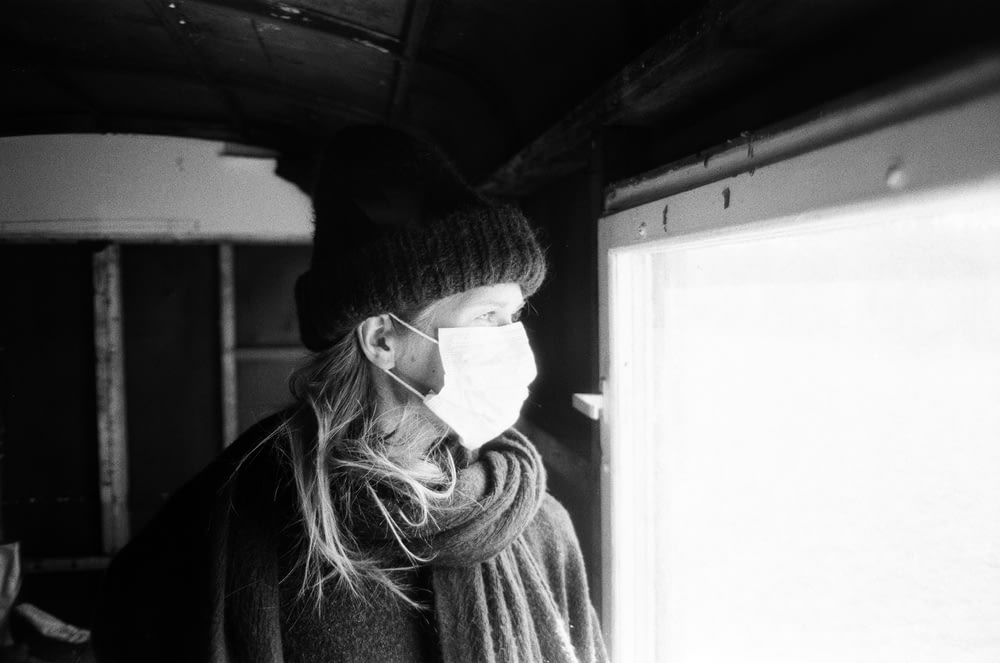 woman in knit cap and sweater in grayscale photography