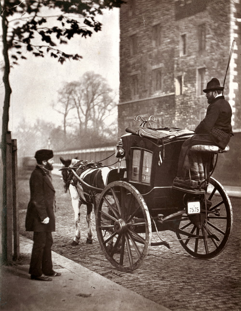man in black coat standing beside horse carriage in grayscale photography