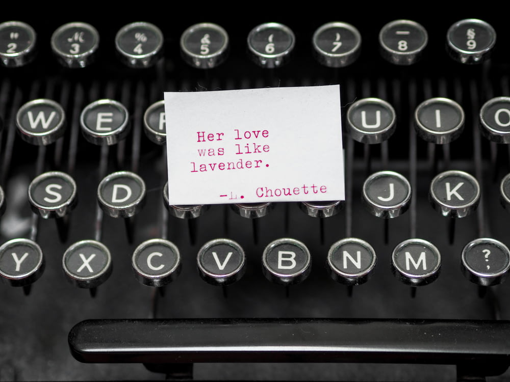 black and white typewriter with white printer paper