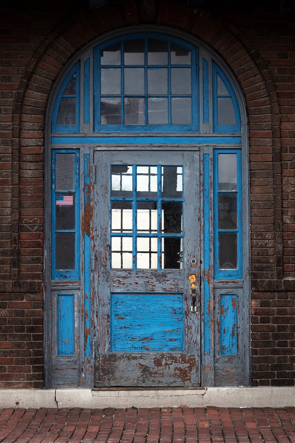 brown wooden door with blue wooden frame