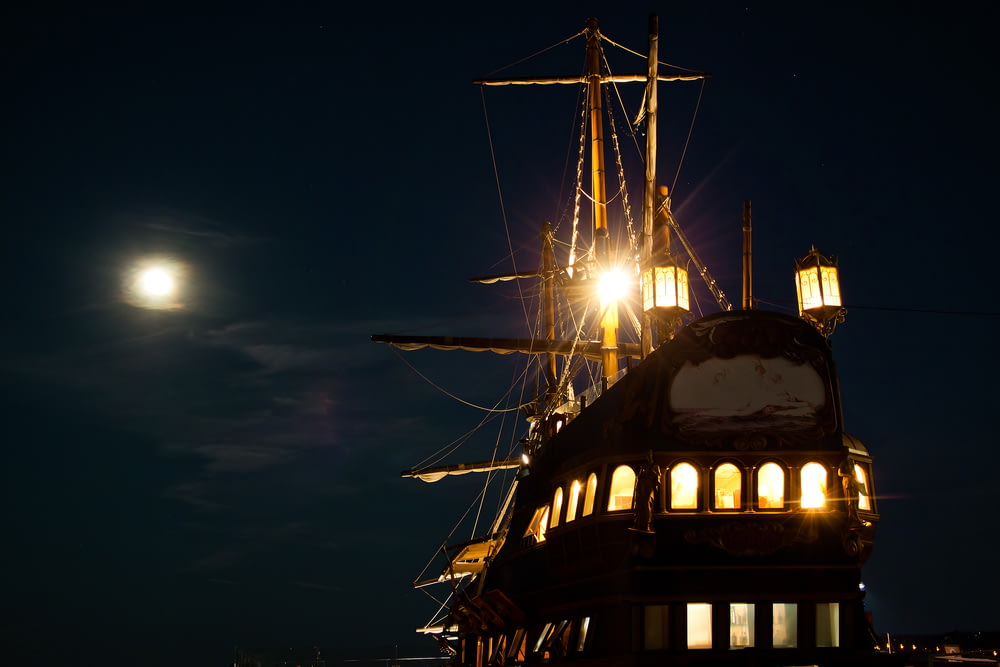 black and brown ship on sea during night time