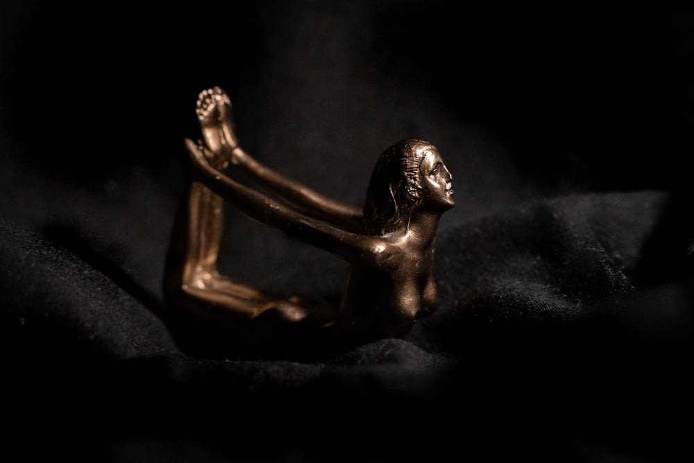 black ceramic figurine on black textile