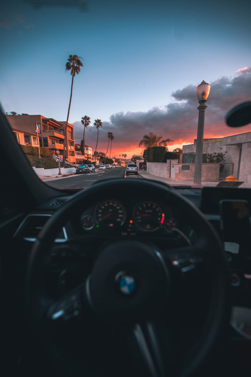black car steering wheel during sunset