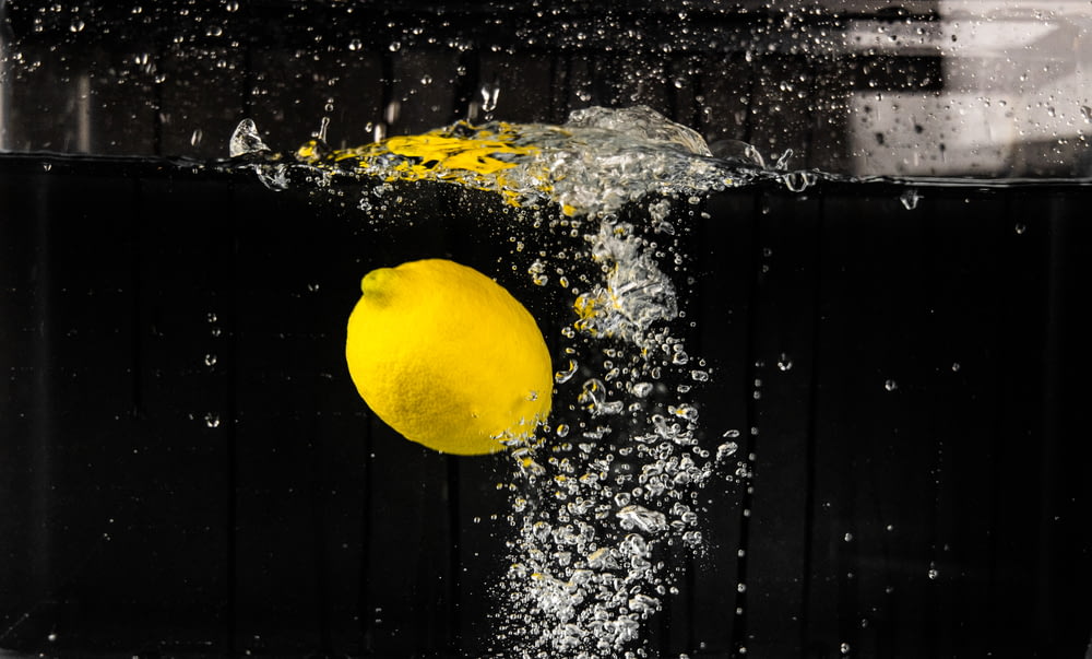 yellow lemon on water during daytime