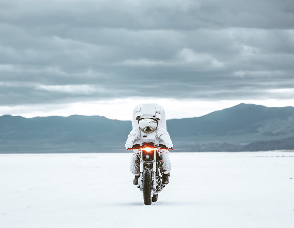 white motorcycle on snow covered ground during daytime