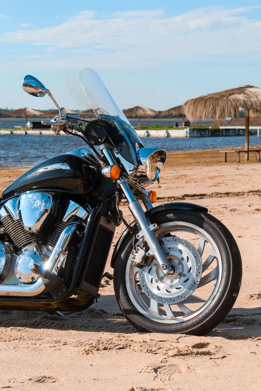 blue and silver cruiser motorcycle on brown sand during daytime