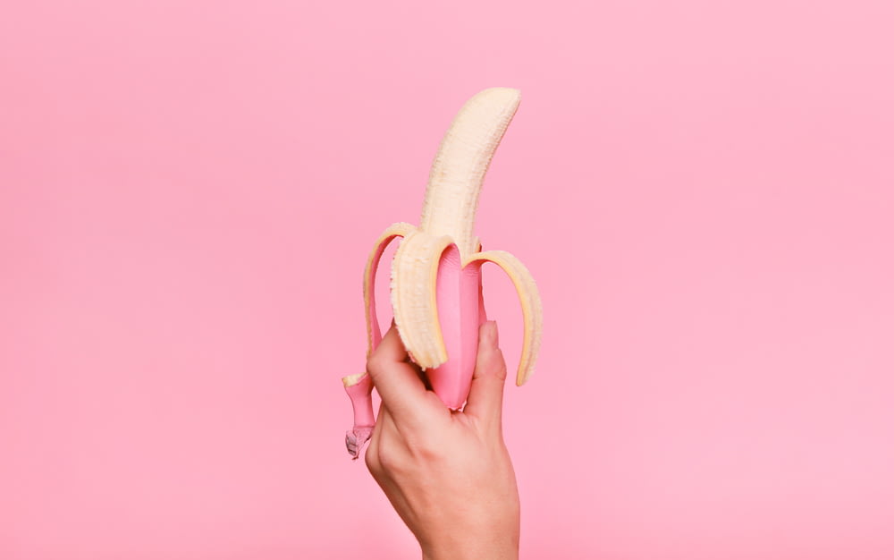 person holding sliced of banana
