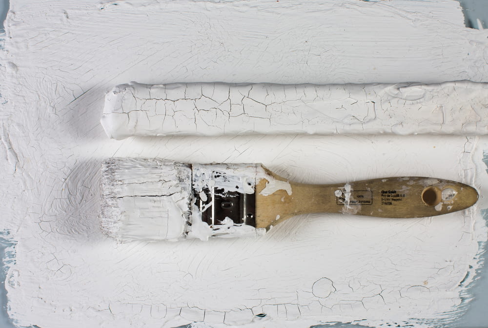 white paint brush on white wall