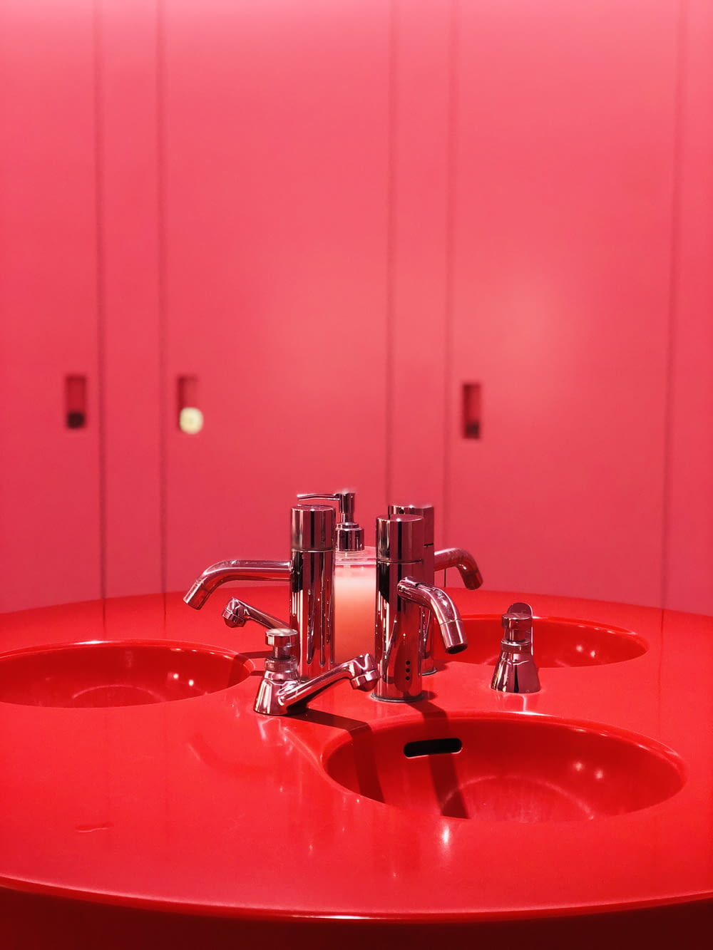 red ceramic sink with stainless steel faucet