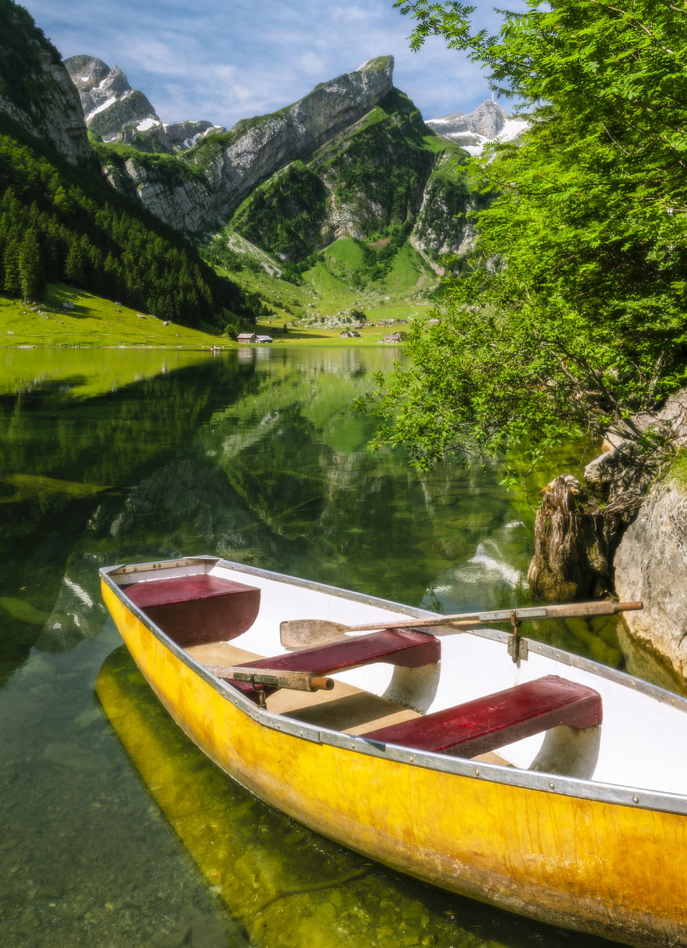 brown wooden boat on lake during daytime