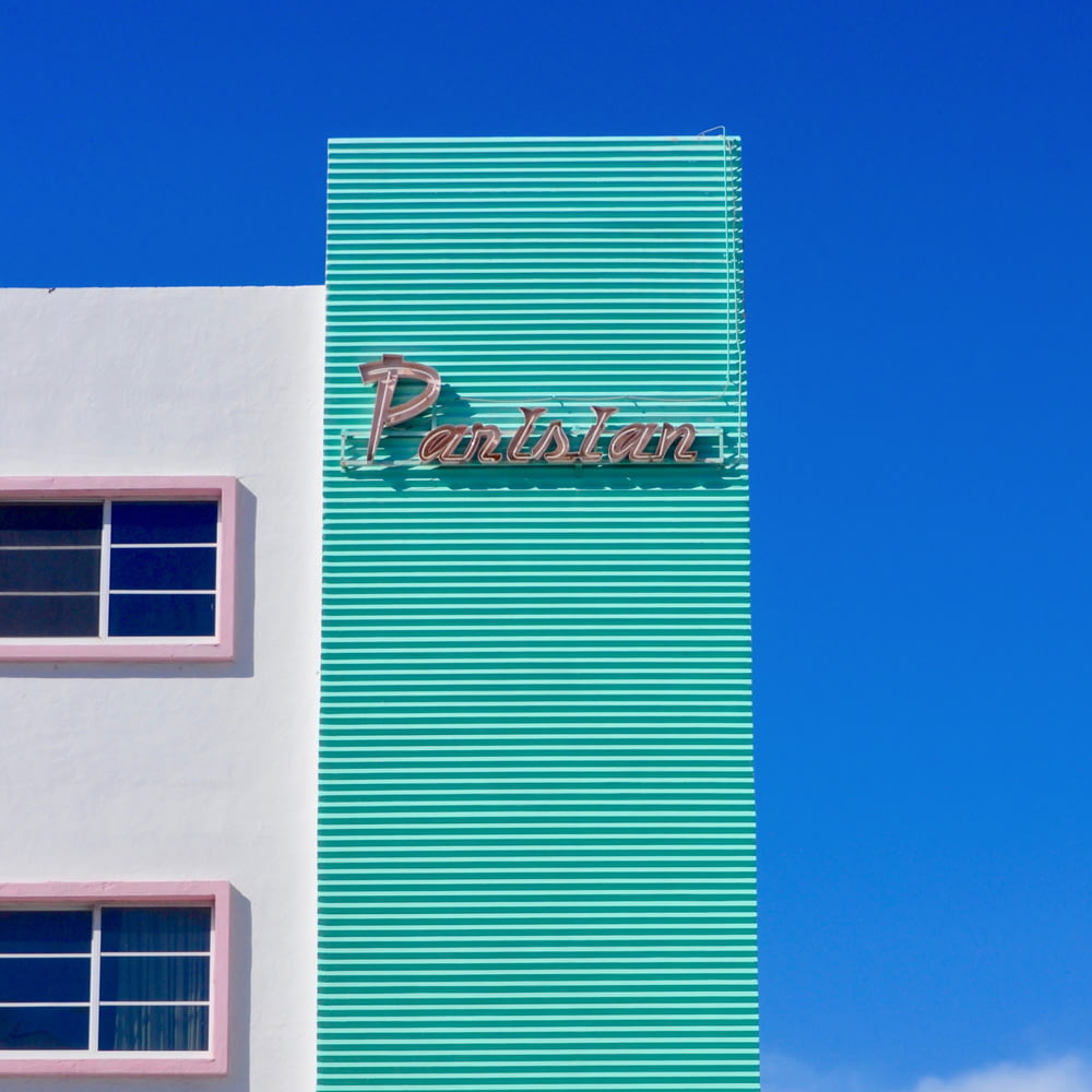 white and teal concrete building under blue sky during daytime