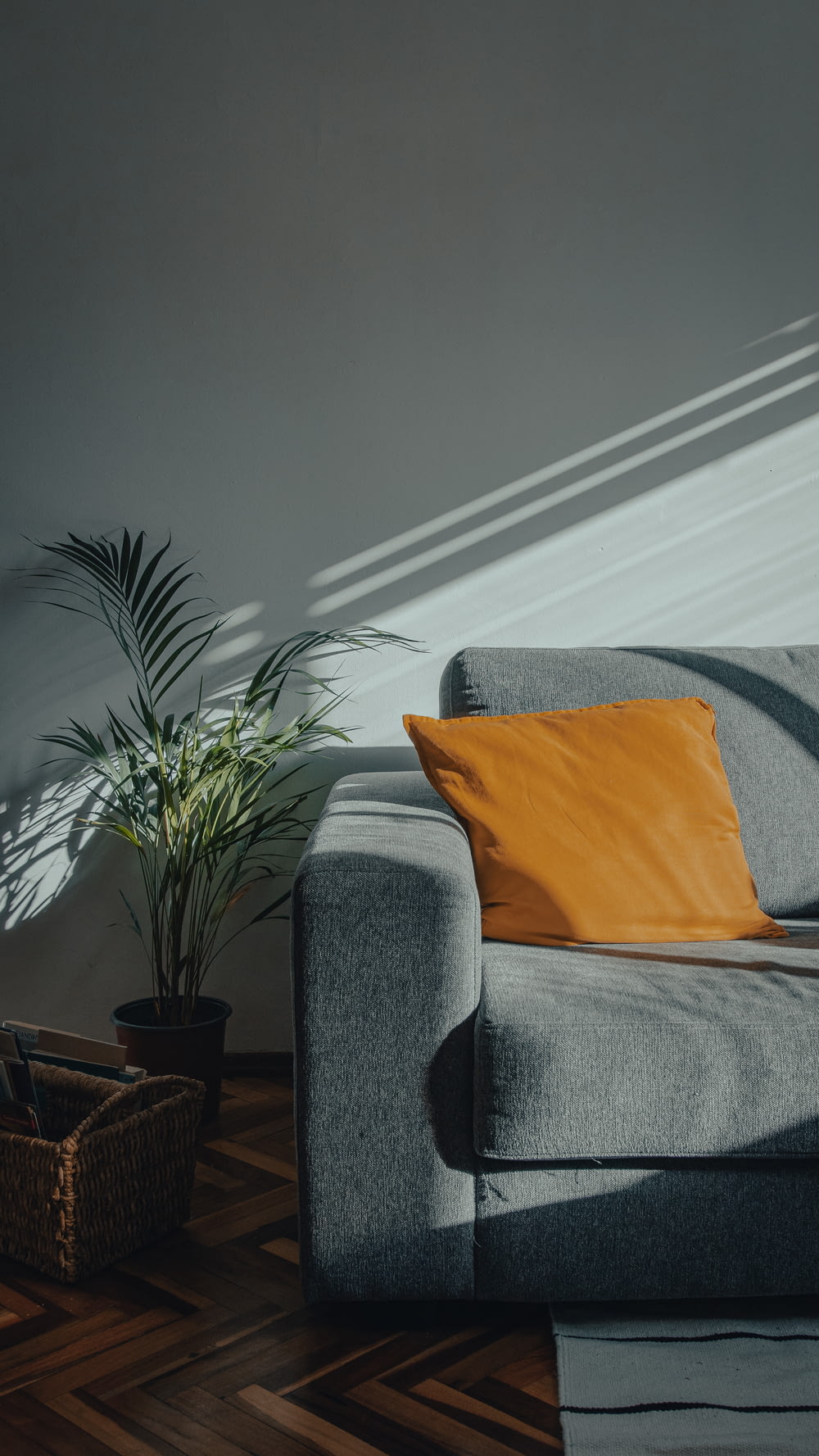 orange throw pillow on gray couch