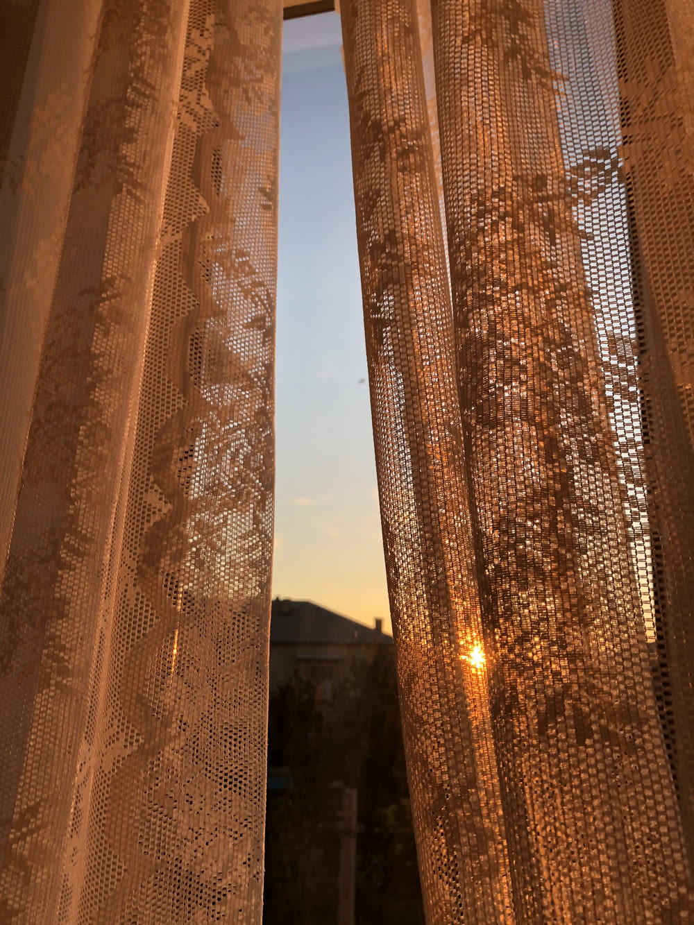 brown floral curtain during sunset