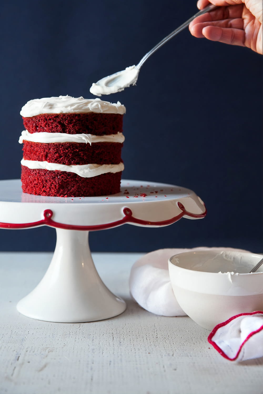 red and white cake on white ceramic cake stand