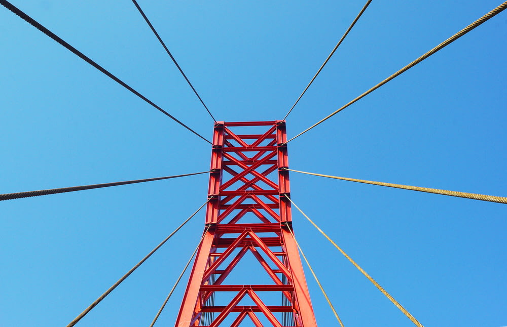 red metal bridge under blue sky during daytime