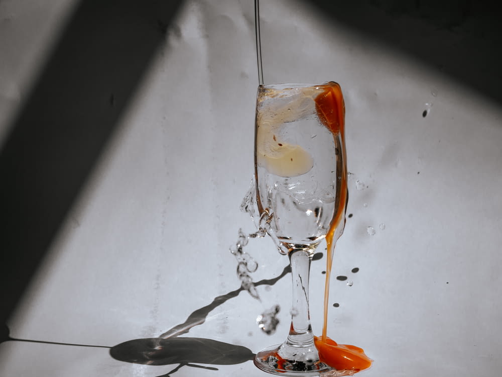 orange liquid in clear drinking glass