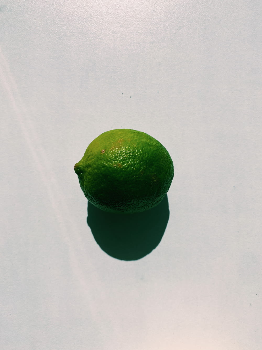 green lemon on white table