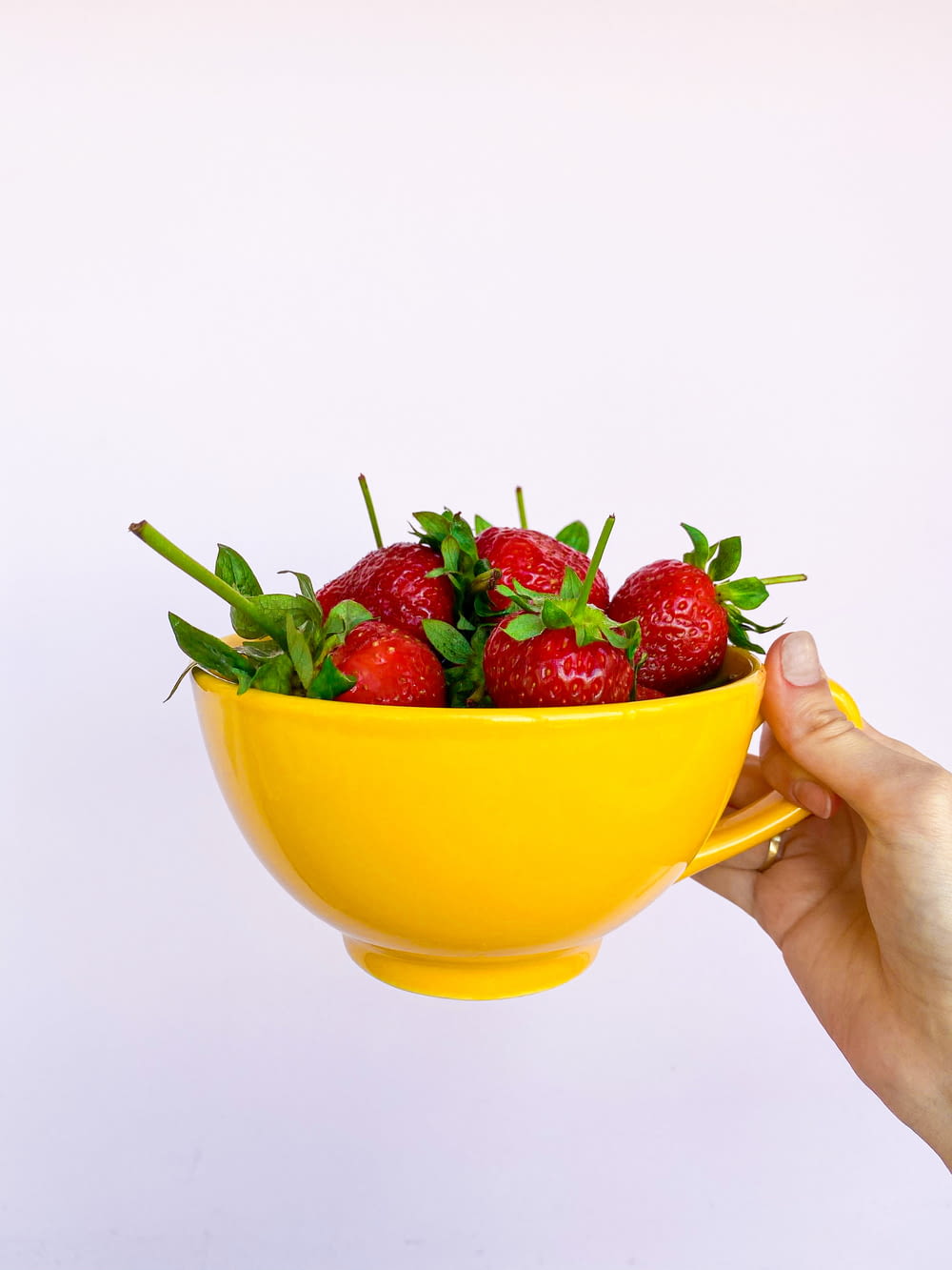 strawberries in yellow ceramic bowl