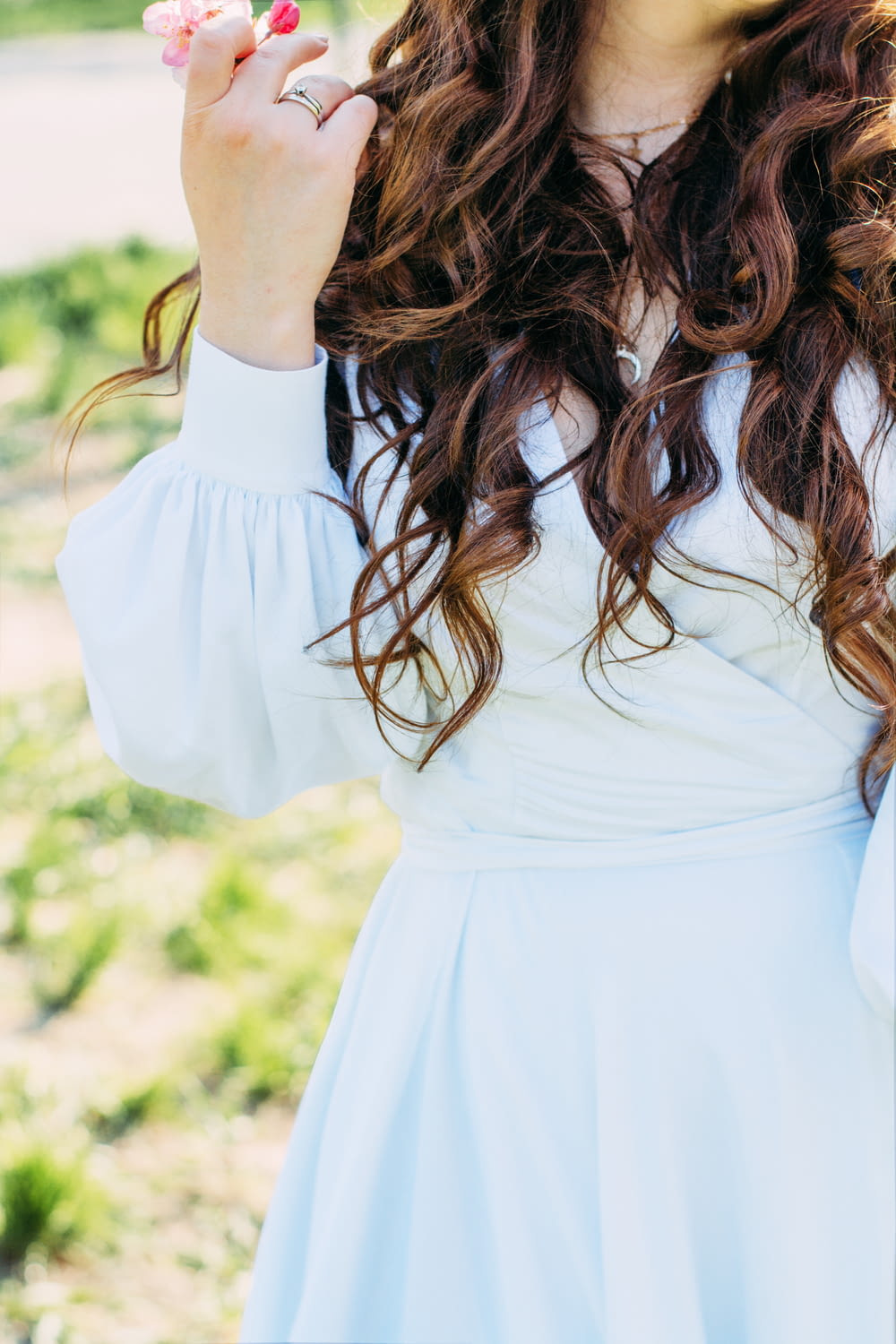 woman in white dress holding her hair