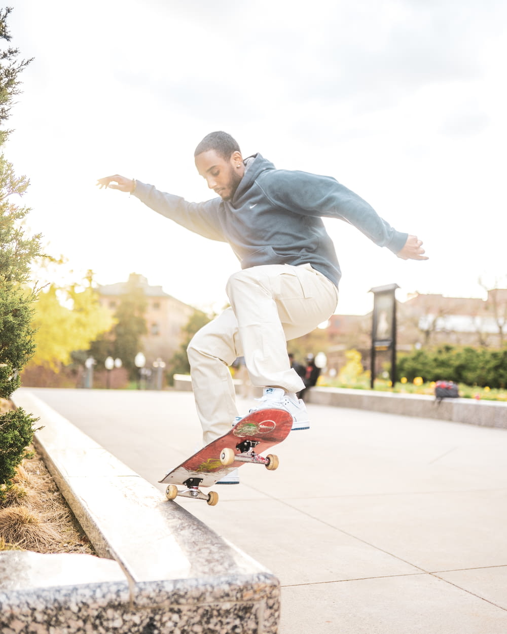 man in gray hoodie and brown pants riding skateboard during daytime