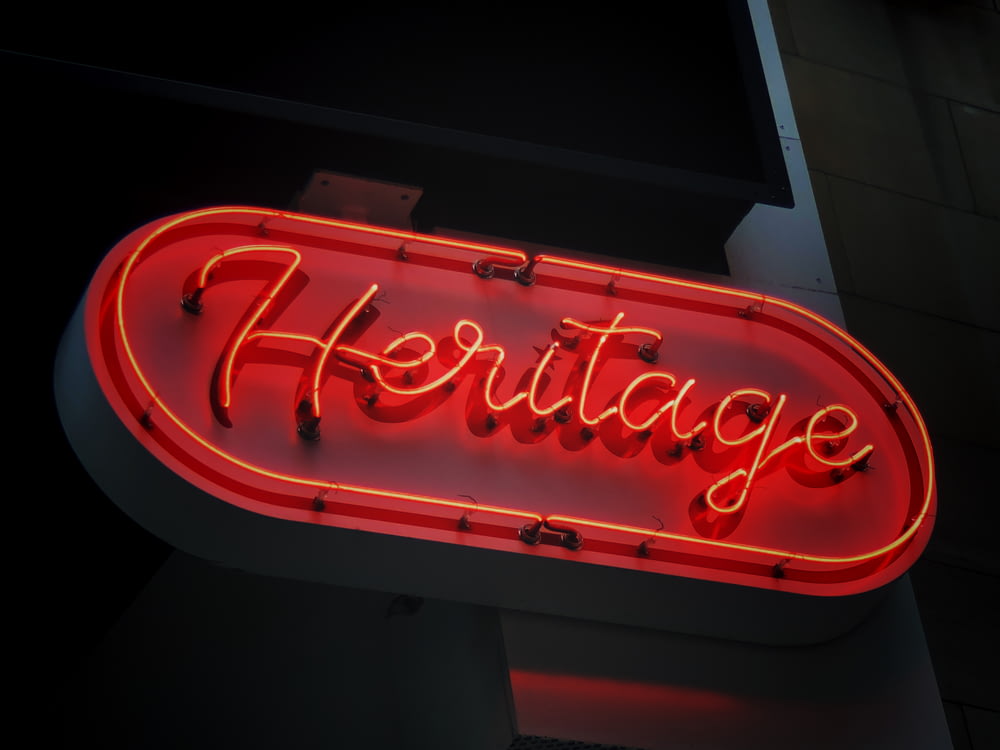 a neon sign that says heritage on it