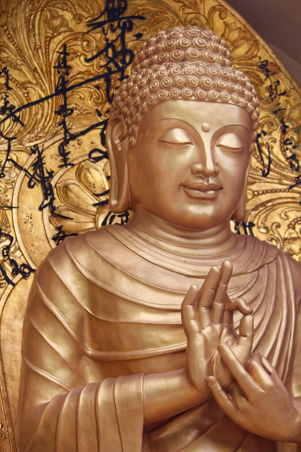 gold buddha statue on brown textile