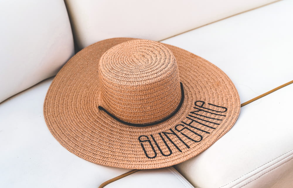 brown straw hat on white table