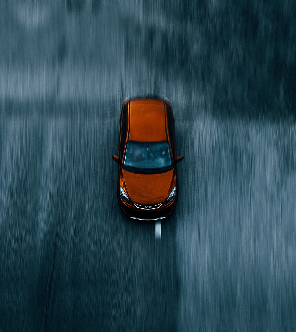 orange and black car on water
