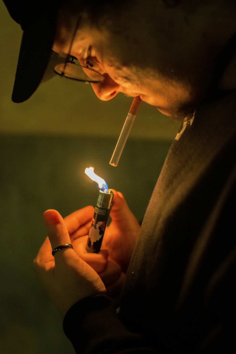 person holding blue disposable lighter
