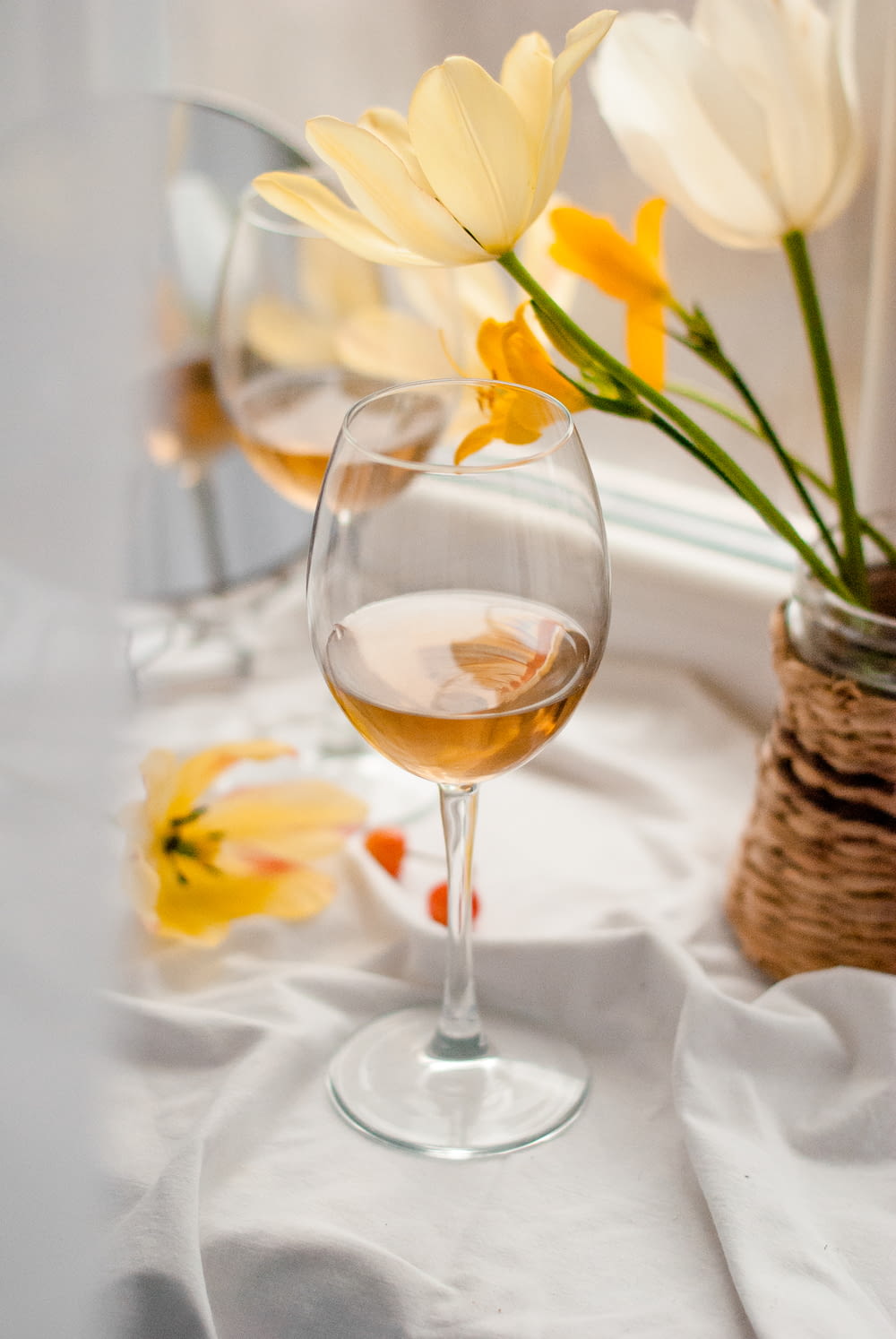 clear wine glass with yellow flower