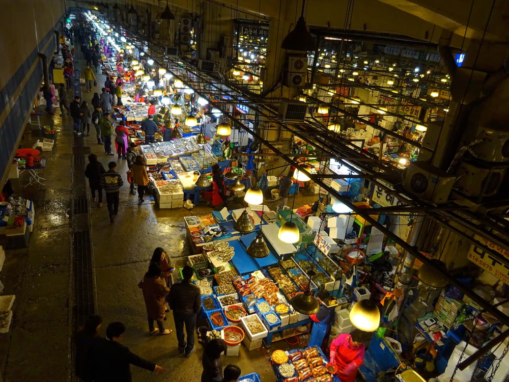 people walking on market during night time
