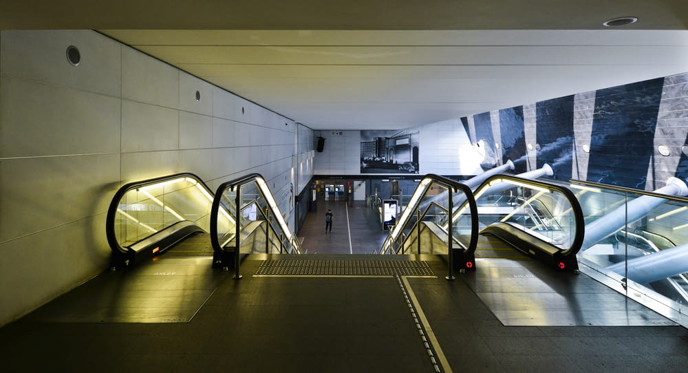 black and white escalator inside building